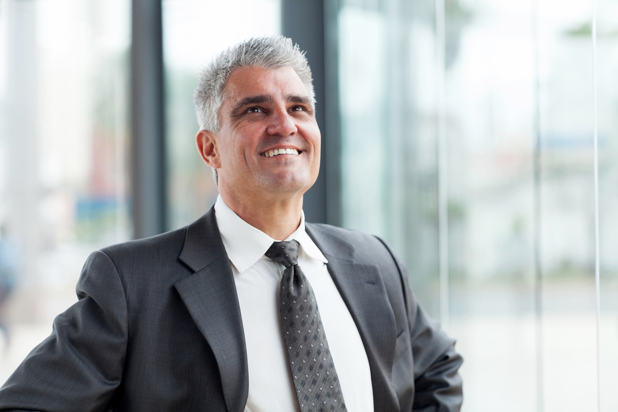 middle-aged businessman looking up